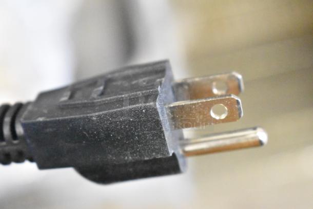 Close-up of a power plug for a Carnival King 382WSM11 Waffle Maker, highlighting a standard two-prong design.