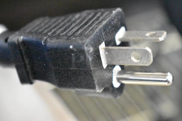 Close-up of a black three-prong plug for the Avantco 177QS1800SS countertop steamer, 120 volts, 1 phase.