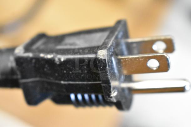 Close-up of a power plug for the ServIt 423FW150 electric countertop food warmer, showing minor scratches.