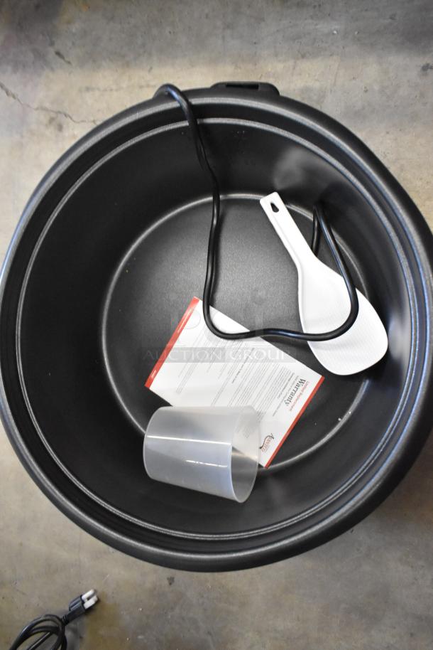 Avantco 177RCB124 stainless steel rice cooker, brand new, showing interior with power cord, scoop, and manual.
