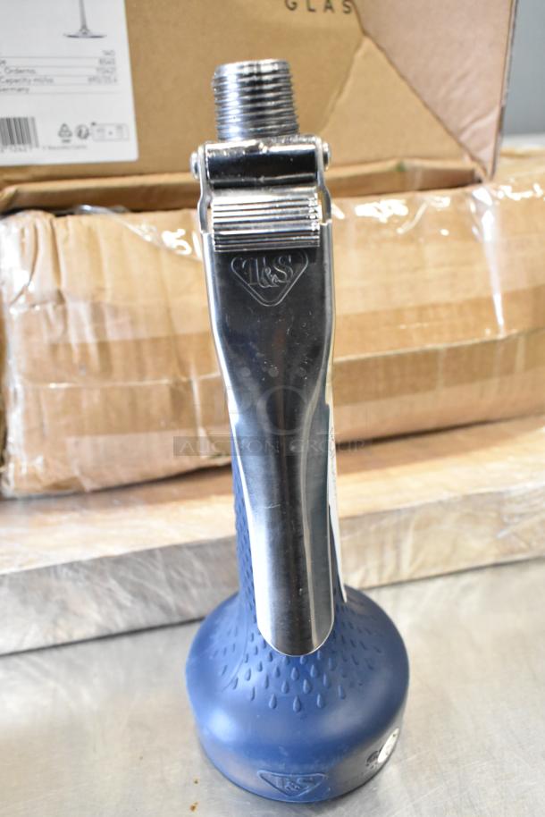 New spray nozzle attachment head, metal and rubber design, brand marked, shown against cardboard box.