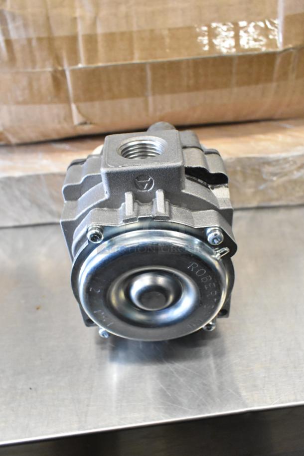 Brand new spray nozzle attachment head, model 82266 MM24179A, with visible markings, shown on a metal surface.