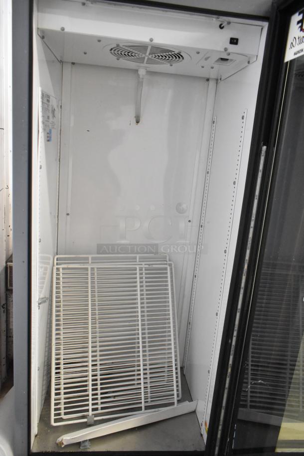 True GDM-12-LD metal cooler, single door, commercial use, 115V, 1 phase. Includes shelving, some wear visible.