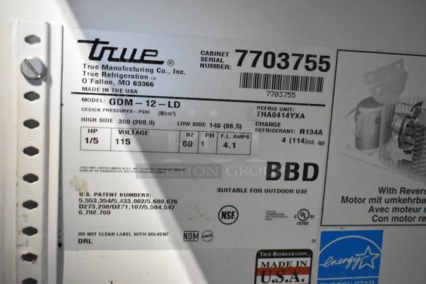 True GDM-12-LD commercial single-door cooler, 115 volts, 1 phase. Model and serial labels visible. Made in USA.