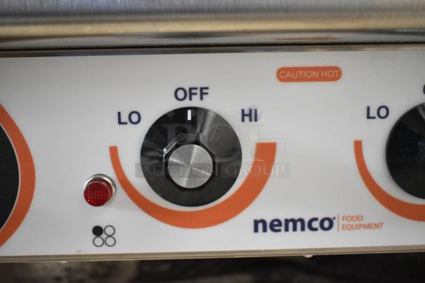 Nemco 6311-4-240 stainless electric hot plate control panel, showing "LO" to "HI" dial, red indicator light, and "CAUTION HOT" label.