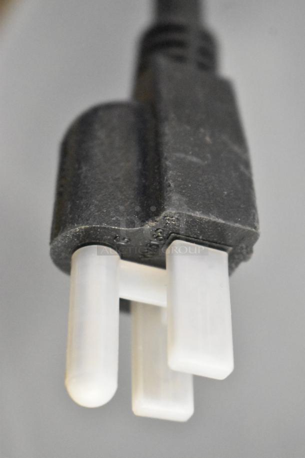 Close-up of a three-prong plug, likely from the 2025 ServIt 423EST3WO electric steam table, emphasizing connector detail.