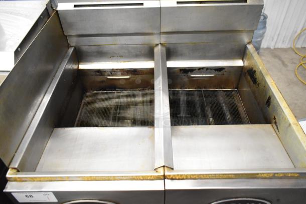 Royal RFT-50 stainless steel commercial 2-bay deep fat fryer with slight wear. Propane gas-powered. Model: RFT-50.