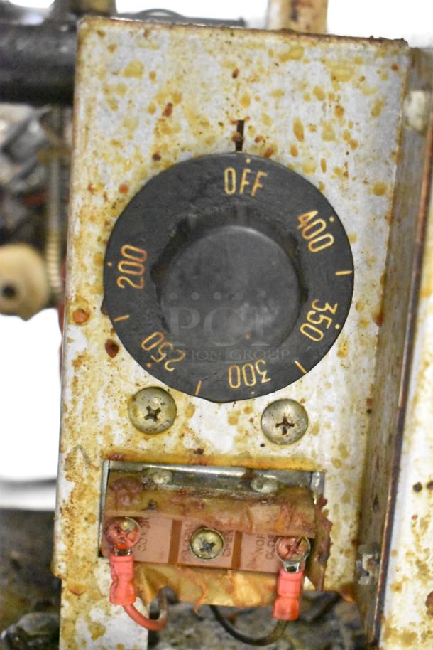 Royal RFT-50 stainless steel fryer control dial showing temperature settings from 200°F to 400°F, with visible wear.