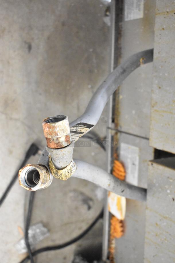 Royal RFT-50 stainless steel propane gas deep fat fryer, 2 bay, commercial use, visible wear on connectors.