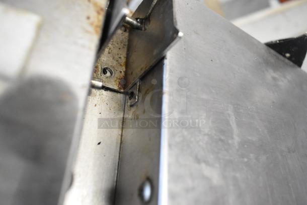 Close-up of 2018 Atosa MPF8202GR stainless steel commercial pizza prep table showing internal corner with bolts and mild wear.