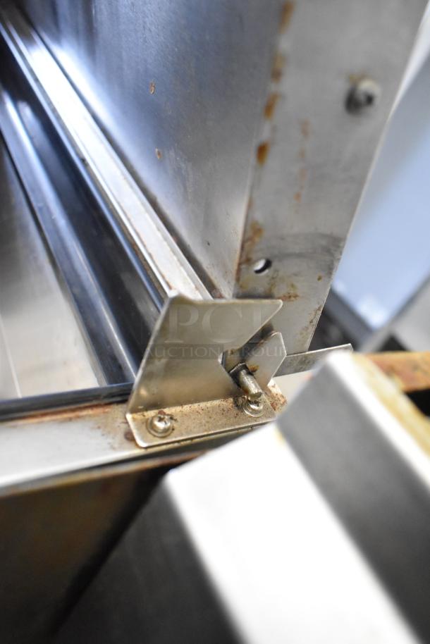 2018 Atosa MPF8202GR stainless steel pizza prep table, detail showing internal hinge wear and oxidation, 115V, 1 phase.