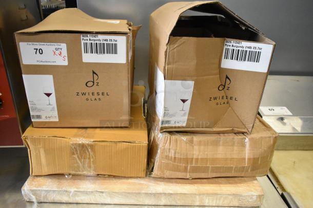 Boxes of Zwiesel Glas Pure 23.7 oz. Burgundy Wine Glasses, Acopa Bright White Square China, and more, showing slight box damage.