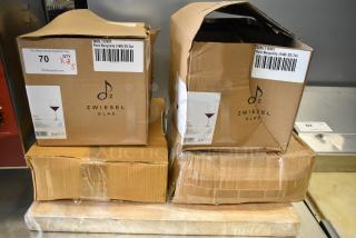 Boxes of Zwiesel Glas Pure 23.7 oz. Burgundy Wine Glasses, Acopa Bright White Square China, and more, showing slight box damage.