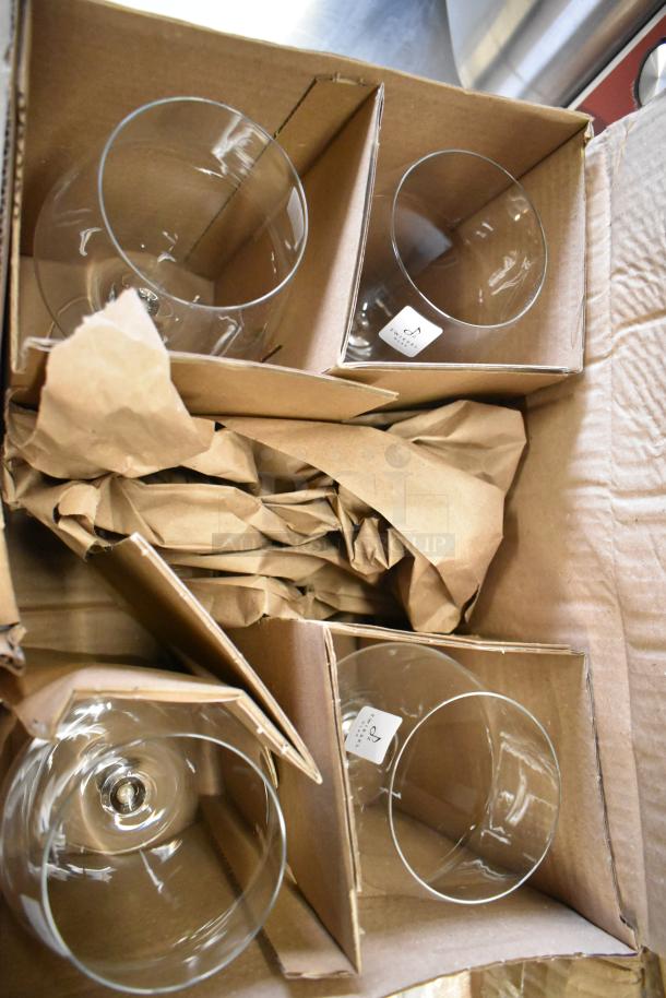 Boxes containing new Zwiesel Glas Pure 23.7 oz. Burgundy wine glasses by Fortessa, packed in cardboard dividers.