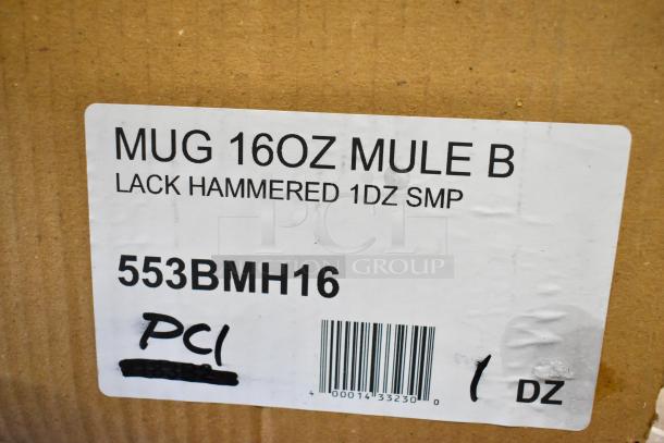 Label on a cardboard box reading "MUG 16OZ MULE B LACK HAMMERED 1DZ SMP," with code "553BMH16" and a barcode.
