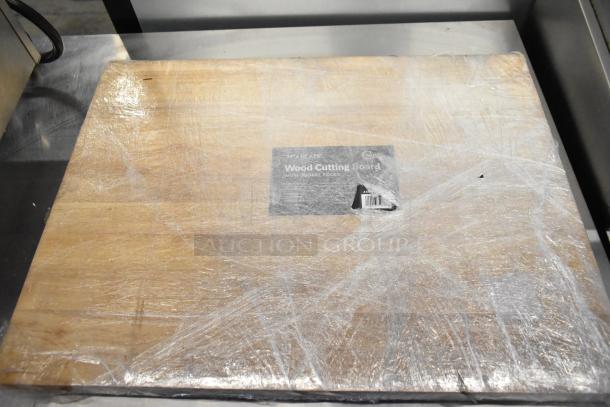 Choice 24" x 18" x 1 3/4" wood cutting board with squared edges, wrapped, showing label.