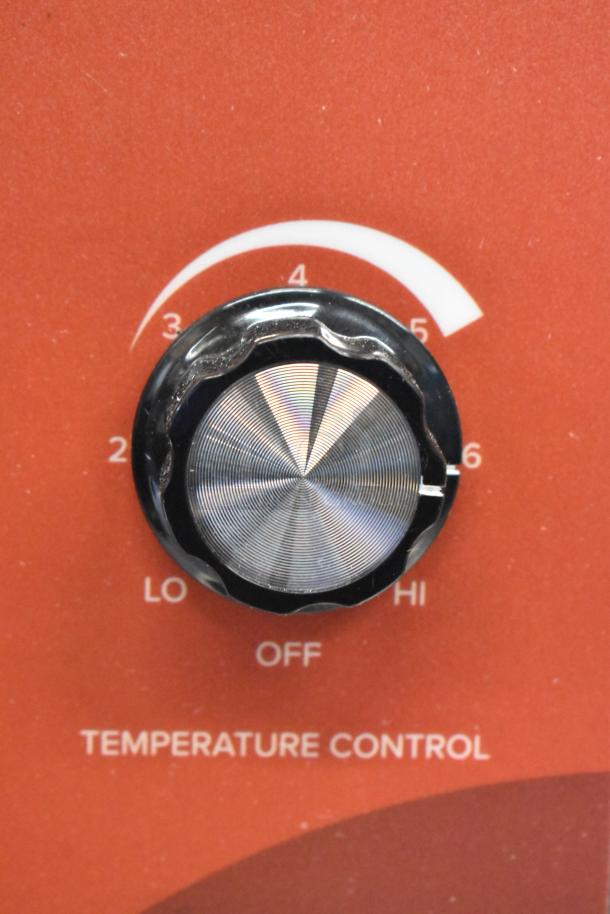 Avantco 177HWD10D hot water dispenser temperature control knob on a red panel, showing settings from low to high.