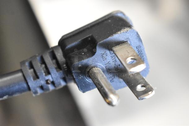 Close-up of a power plug for the Atosa MGF8402GR cooler, showing a standard three-prong plug in good condition.