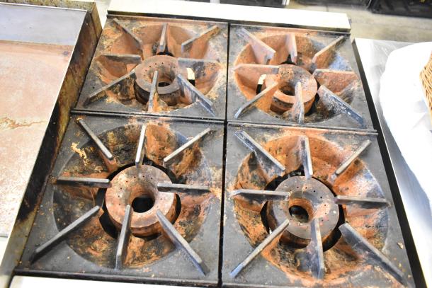 Royal RHP-24-4 stainless steel 4-burner propane range, 30,000 BTU. Used condition with rust on burners.