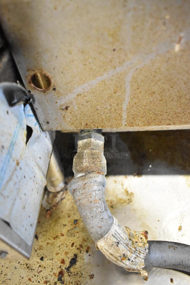 Royal stainless steel commercial gas griddle in used condition, showing gas connection and wear. Ideal for countertop use.