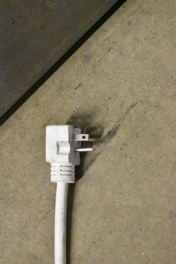 Turbo Air TGF-35SDB-N freezer power cord on concrete floor, showing 115V plug, suitable for commercial use.