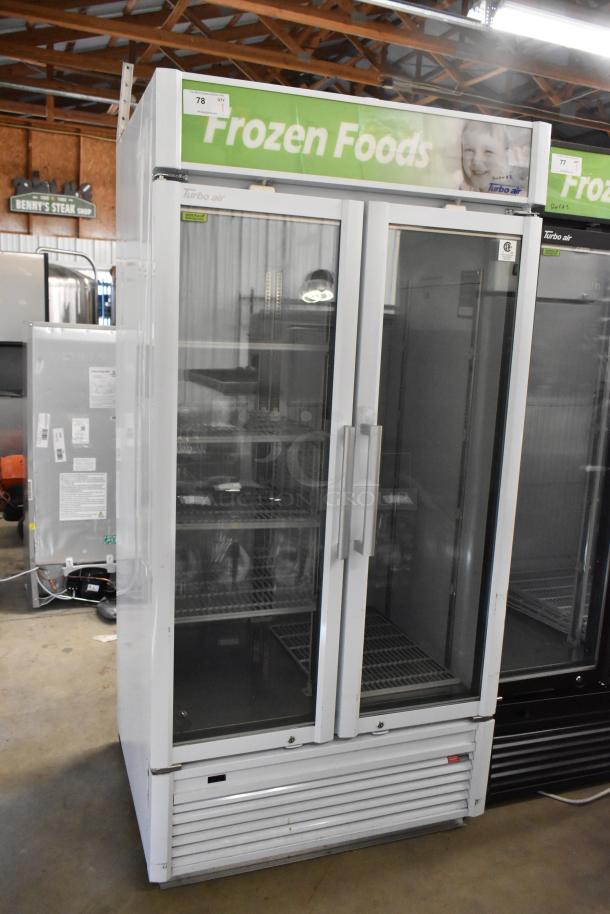 Turbo Air TGF-35SDW-N commercial freezer, two glass doors, poly coated racks, 115V, excellent condition, visible "Frozen Foods" sign.
