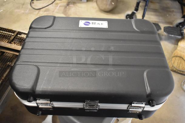 Rae Systems hard case, black with textured surface, metal latches, and Rae logo on label. Sturdy condition.