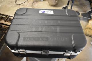 Rae Systems hard case, black with textured surface, metal latches, and Rae logo on label. Sturdy condition.