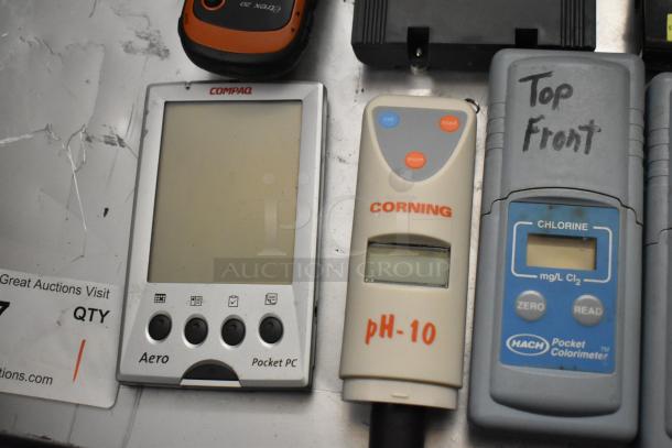 15 assorted devices including Compaq Aero Pocket PC, Corning pH-10 meter, and Hach chlorine colorimeter, all in used condition.