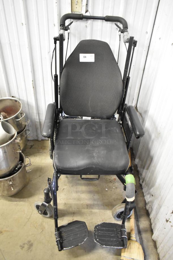 Comfort Ascent Wheelchair with cushioned seat and backrest in good condition. Features adjustable armrests and footrests. Product tag visible on backrest.
