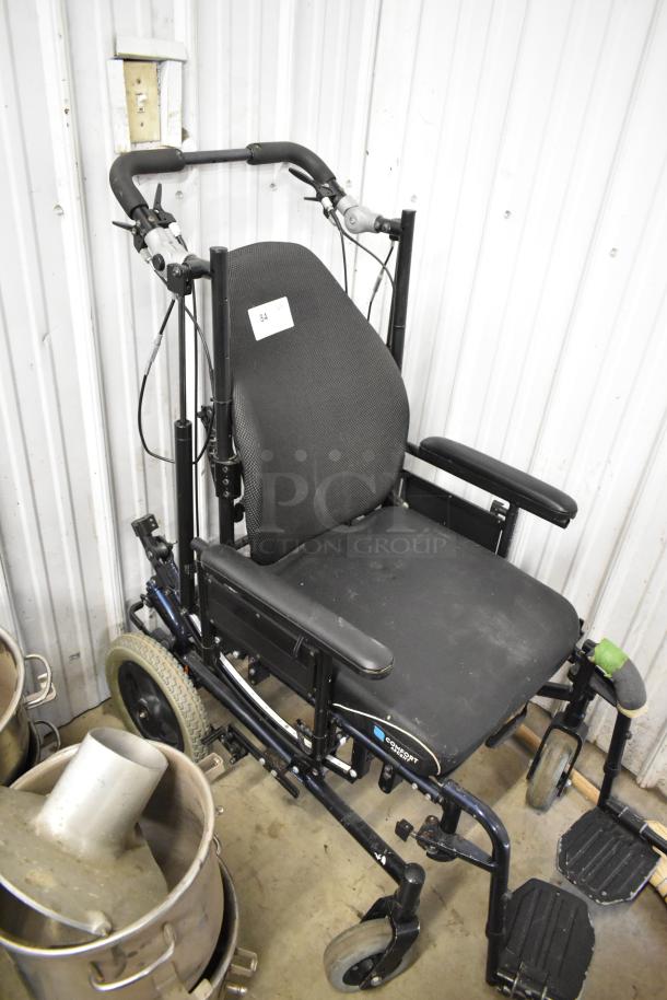 Comfort Ascent Wheelchair, black with padded seat and backrest, footrests, and push handles. Good condition, label with "84."