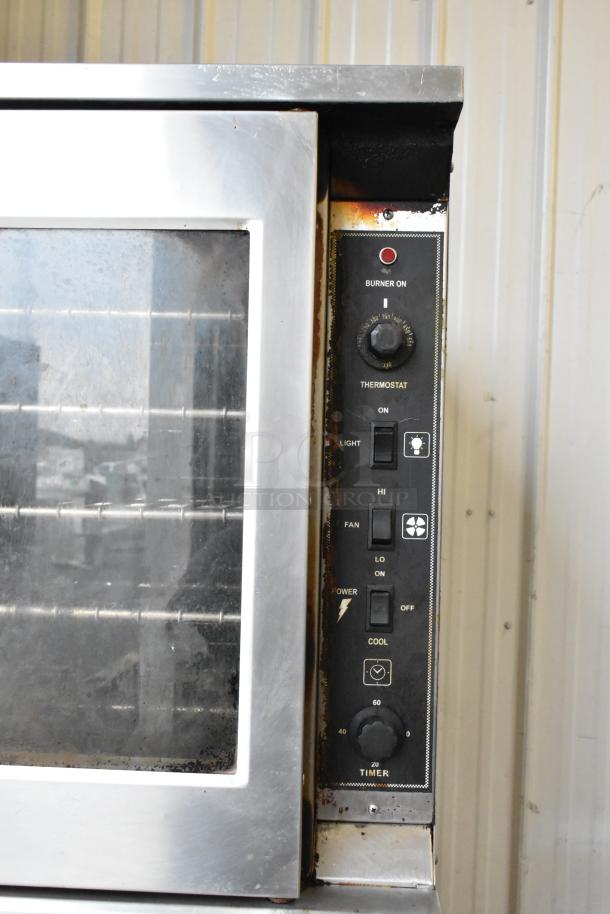 Royal RCOD-1 stainless steel convection oven, natural gas-powered, view-through door, thermostatic controls, metal racks, on casters.