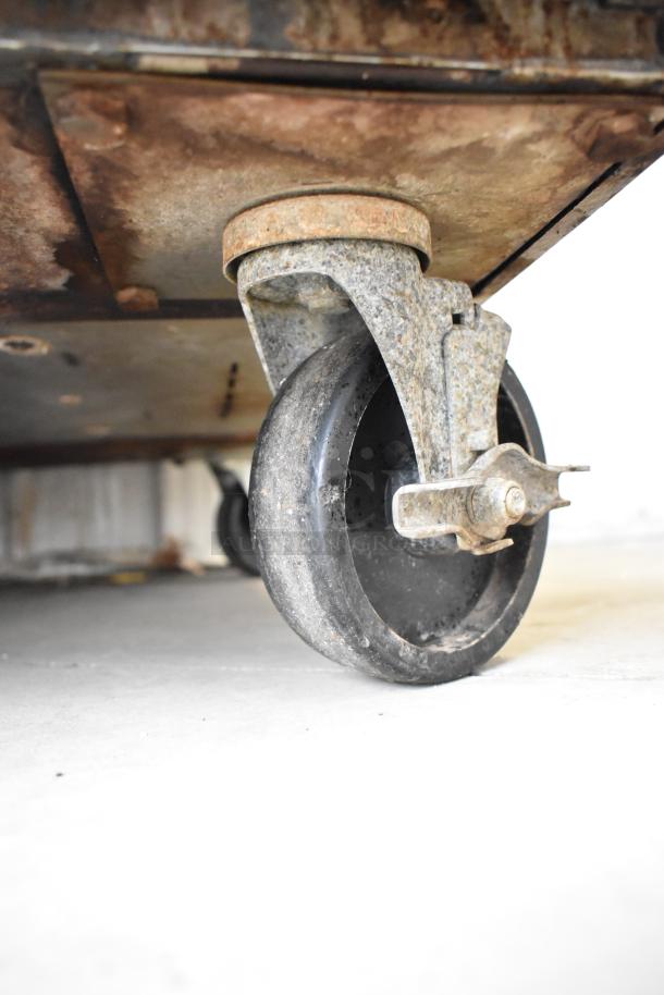 Rusty caster wheel of Royal RCOD-1 convection oven on commercial casters. Metal frame shows wear and surface rust.