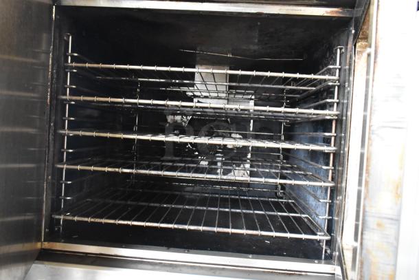 Royal RCOD-1 stainless steel convection oven interior with metal racks, solid door, and commercial casters.