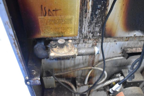 Interior view of Royal RCOD-1 convection oven showing gas connection and wiring. Visible wear and labeling "NAT."