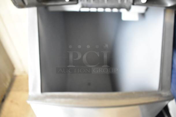 Manitowoc IY0524A-161 stainless steel ice machine head on bin, 115V, 1 phase, commercial use, empty interior view.