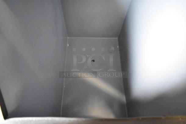 Stainless steel commercial ice bin interior, part of Manitowoc IY0524A-161 ice machine. Clean condition, no visible wear.
