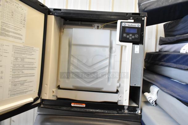 Manitowoc IY0524A-161 commercial ice machine head on bin, stainless steel, half cube, 115V, electronic controls visible.