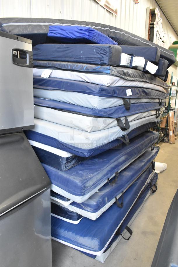Stack of 25 blue and gray pads, various sizes, good condition, with handles for carrying, auction item.