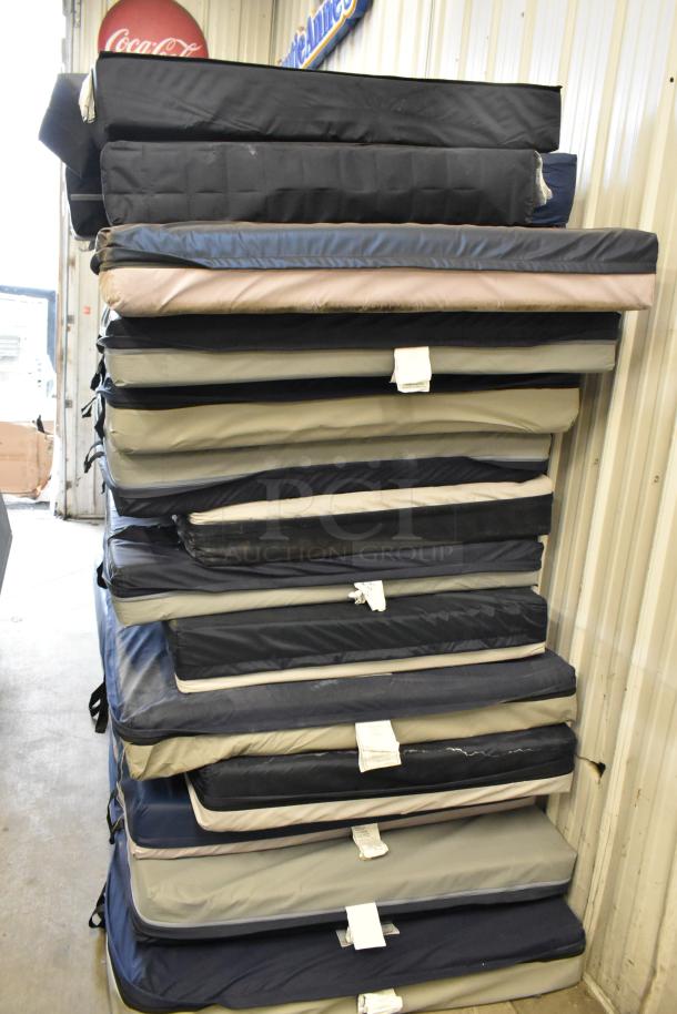 Stack of 25 various pads in assorted colors, some with visible tags. Auction item for bulk purchase, 25 times your bid.