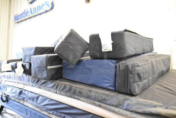 Stack of 25 various pads, mixed sizes and colors, in used condition. Includes protective covers. Auction lot of 25 pieces per bid.