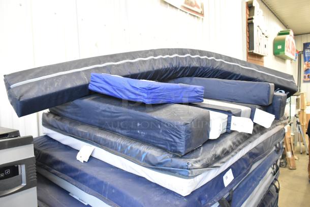 Stack of 25 assorted pads in varying colors and conditions, tagged for auction.