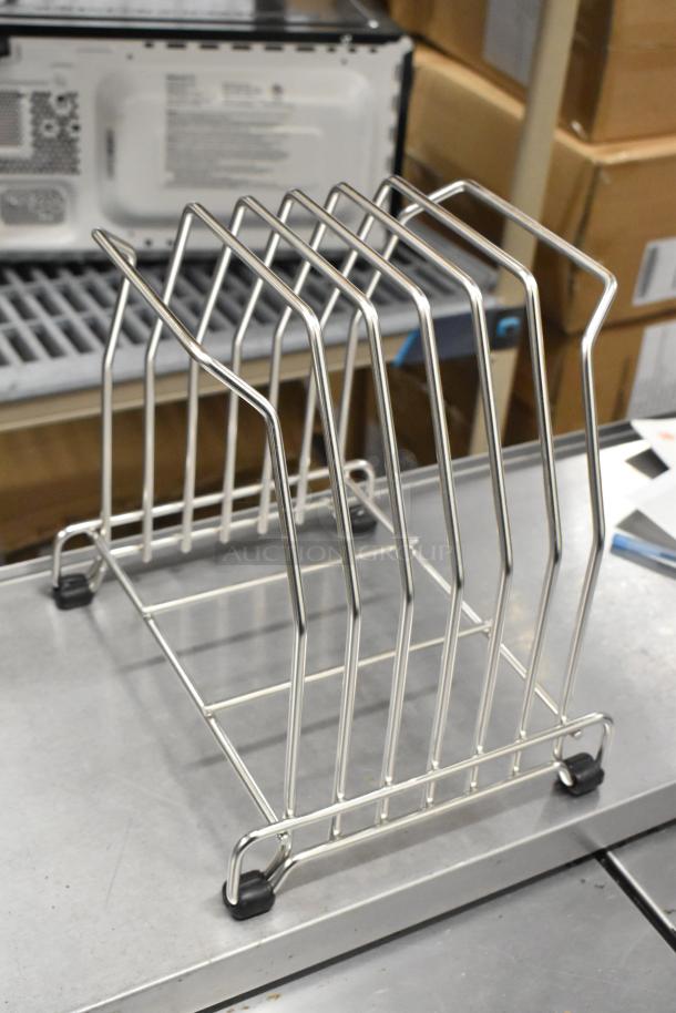 Metal drying rack with several slots, chrome finish, rubber feet, used condition. Auction includes 2 other items.