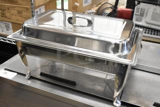 Brand new stainless steel chafing dish, scratch and dent condition, rectangular with smooth finish and sturdy legs.