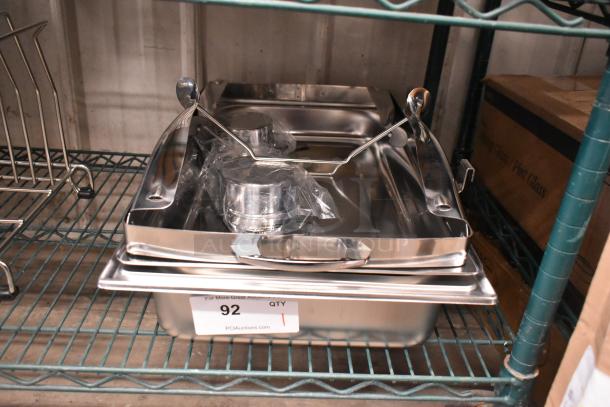 Brand new stainless steel chafing dish with minor scratches and dents, includes lid and fuel holders. Quantity tag visible.