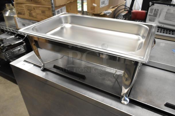 Stainless steel chafing dish with slight scratches, brand new, features elegant curved legs, ideal for catering events.