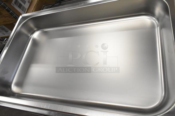 Brand new stainless steel chafing dish, minor scratches, robust design, ideal for catering and buffet use.