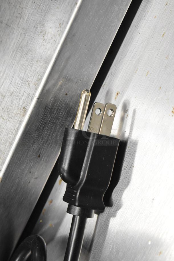 Power plug for Waring BB145S BevBasix 32 oz. commercial blender, 120V, seen against stainless steel surface.