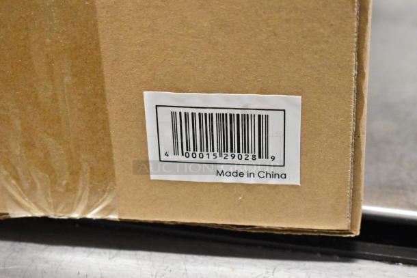 Brown cardboard box with barcode label indicating "Made in China." Box contains Acopa Pangea stemless wine glasses and Keystone stoneware creamers.