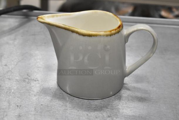 Acopa Keystone 10 oz. granite gray stoneware creamer with small chip on the spout, curved handle, brand new condition.